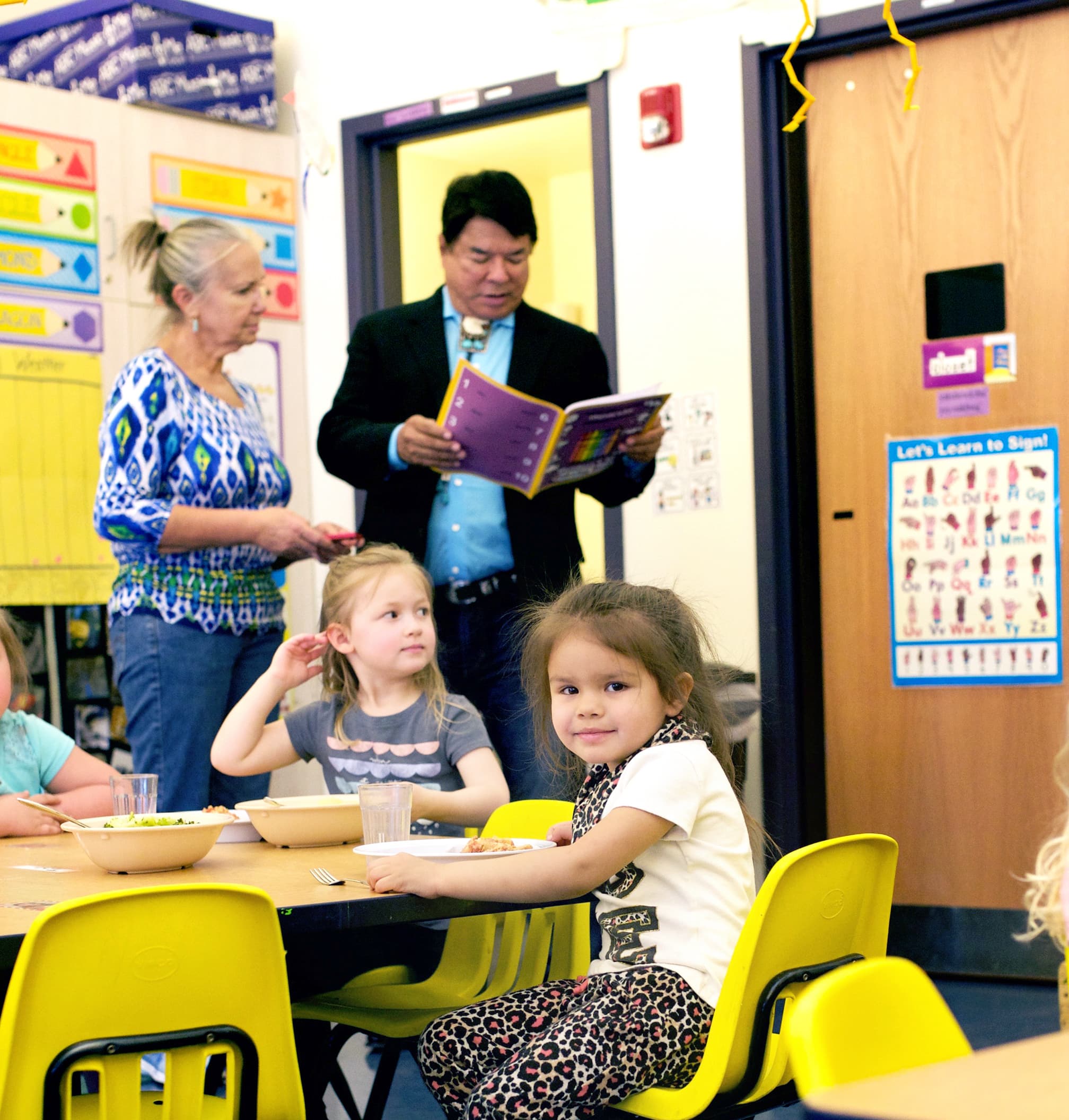 A photo of Ray Halbritter reading to children